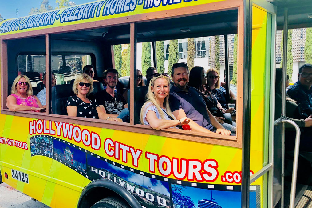 Hollywood City Tours open-top bus driving through Hollywood Boulevard